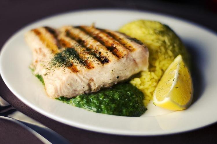 Fish, sauces, and lemon slice